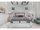 Spacious main bedroom with brick wall, beamed ceiling, and plush rug at 8127 E June St, Mesa, AZ 85207