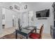 This bright office features a vintage desk, modern computer, hardwood floors, and a flat screen TV at 8127 E June St, Mesa, AZ 85207