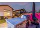 Backyard outdoor kitchen and BBQ area at dusk with bar, wicker seating, and a lighted backyard at 8127 E June St, Mesa, AZ 85207