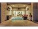 A cozy patio area with textured walls, comfortable seating, and a decorative rug at 8127 E June St, Mesa, AZ 85207