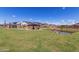 Community green space and pond featuring an open lawn and shaded picnic pavilion area at 8127 E June St, Mesa, AZ 85207
