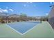Brightly colored community tennis court with a black chainlink fence at 8127 E June St, Mesa, AZ 85207