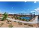 Community tennis court with a black chainlink fence and surrounded by desert landscaping at 8127 E June St, Mesa, AZ 85207