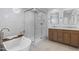 Contemporary bathroom boasts a soaker tub, modern shower, and stylish vanity with stone counters at 8430 E Fairmount Ave, Scottsdale, AZ 85251