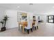 Bright dining area with modern art and a glimpse into the open living space at 8430 E Fairmount Ave, Scottsdale, AZ 85251