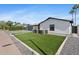 Charming home exterior showcasing a modern design, well-manicured artificial lawn, and striking curb appeal at 8430 E Fairmount Ave, Scottsdale, AZ 85251