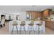 Spacious kitchen island featuring counter seating, a sink, and modern fixtures at 8430 E Fairmount Ave, Scottsdale, AZ 85251