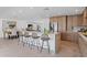 Kitchen island with barstools and open view into living room and dining room at 8430 E Fairmount Ave, Scottsdale, AZ 85251