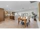 Open kitchen and dining area with wood cabinetry, marble countertops, and modern stainless steel appliances at 8430 E Fairmount Ave, Scottsdale, AZ 85251