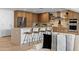 Contemporary kitchen with stainless steel appliances, breakfast bar, and light wood cabinetry at 8430 E Fairmount Ave, Scottsdale, AZ 85251