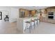 Kitchen featuring large island, stainless steel refrigerator, and easy access to adjacent room at 8430 E Fairmount Ave, Scottsdale, AZ 85251