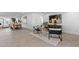 Open-concept living area with neutral tones, tile floors, sleek furniture, and an abundance of natural light at 8430 E Fairmount Ave, Scottsdale, AZ 85251