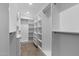 Spacious walk-in closet with custom shelving, drawers, and rods for optimal organization at 8430 E Fairmount Ave, Scottsdale, AZ 85251