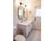 Bathroom featuring a double sink vanity, modern fixtures and tile flooring at 864 W Monte Ave, Mesa, AZ 85210