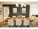 Dining room with an elegant table setting, modern wallpaper, stylish lighting, and seating for eight at 864 W Monte Ave, Mesa, AZ 85210