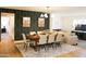 Open dining room area featuring a large wooden table, seating for eight, and easy access to the living room at 864 W Monte Ave, Mesa, AZ 85210