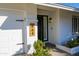 Charming home featuring a black front door with a wooden address plate and a white brick exterior at 864 W Monte Ave, Mesa, AZ 85210