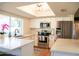 Bright kitchen featuring stainless steel appliances, white cabinets, and a large window for natural light at 864 W Monte Ave, Mesa, AZ 85210