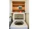 Bright laundry area with white Samsung washer and storage cabinets above, offering convenient laundry solutions at 864 W Monte Ave, Mesa, AZ 85210