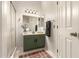 Bathroom featuring a green vanity with modern lighting and a shower with a glass door at 875 S Nebraska St # 69, Chandler, AZ 85225