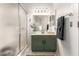 Bathroom featuring a green vanity with modern lighting and a shower with a glass door at 875 S Nebraska St # 69, Chandler, AZ 85225