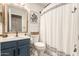 Bathroom with a navy vanity, framed mirror, and white shower curtain at 875 S Nebraska St # 69, Chandler, AZ 85225