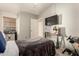 Bedroom with a comfortable bed, gaming setup, and neutral color scheme at 875 S Nebraska St # 69, Chandler, AZ 85225