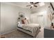 Cozy bedroom with a rustic headboard, stylish decor, and a ceiling fan for added comfort at 875 S Nebraska St # 69, Chandler, AZ 85225