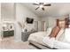 Relaxing bedroom featuring a modern ceiling fan, neutral decor, and an adjacent bathroom at 875 S Nebraska St # 69, Chandler, AZ 85225