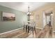 Bright dining area featuring an elegant chandelier, modern table set, and stylish wall decor at 875 S Nebraska St # 69, Chandler, AZ 85225
