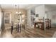 Bright dining area featuring an elegant chandelier, modern table set with view of the kitchen at 875 S Nebraska St # 69, Chandler, AZ 85225
