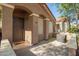 A single-story house with an arched entryway, security door and covered porch at 875 S Nebraska St # 69, Chandler, AZ 85225