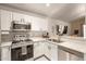 Efficient kitchen featuring modern stainless steel appliances, sleek white cabinets, and ample counter space at 875 S Nebraska St # 69, Chandler, AZ 85225