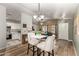 Open-concept living space with modern barstools and chandelier, and hardwood floors at 875 S Nebraska St # 69, Chandler, AZ 85225