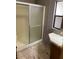 Bathroom featuring a shower stall unit and laminate flooring, blending practicality at 9427 E University Dr # 48, Mesa, AZ 85207