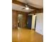 Wood paneled bedroom showing lighting with ensuite access and closet doors at 9427 E University Dr # 48, Mesa, AZ 85207