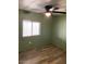 Cozy bedroom with ceiling fan and wood-look flooring, ready for relaxation at 9427 E University Dr # 48, Mesa, AZ 85207