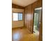 Wood paneled bedroom showcasing natural light and an ensuite bathroom at 9427 E University Dr # 48, Mesa, AZ 85207