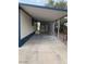Wide covered carport with concrete flooring and a view of the front door at 9427 E University Dr # 48, Mesa, AZ 85207