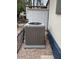 External view of the house's AC unit, with gravel and a small fence at 9427 E University Dr # 48, Mesa, AZ 85207
