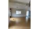 Bright living room with neutral walls, laminate floors, and a large window providing natural light at 9427 E University Dr # 48, Mesa, AZ 85207
