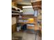 View of a shed interior, featuring shelving units and a workbench at 9427 E University Dr # 48, Mesa, AZ 85207