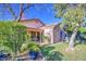 Backyard view featuring a patio, a house, and shrubs at 9967 W Devonshire Ave, Phoenix, AZ 85037
