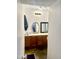 Hall bathroom featuring double sinks with wood cabinetry and a neutral design at 9967 W Devonshire Ave, Phoenix, AZ 85037