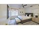 A stylish bedroom featuring a comfortable bed, modern decor, and a window with natural light at 9967 W Devonshire Ave, Phoenix, AZ 85037