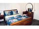 Cozy bedroom with a full size bed, decorative pillows and a mirrored vanity set at 9967 W Devonshire Ave, Phoenix, AZ 85037
