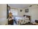 Bedroom featuring slate floors, a small window, and a floral bedspread at 9967 W Devonshire Ave, Phoenix, AZ 85037