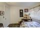Neutral bedroom featuring a bed, tiled floor, and shelving with decor at 9967 W Devonshire Ave, Phoenix, AZ 85037