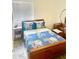 Charming bedroom featuring a bed with blue patterned bedding and a vanity set at 9967 W Devonshire Ave, Phoenix, AZ 85037
