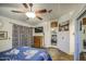 Bedroom featuring slate flooring, a ceiling fan, and an adjacent mirrored closet space at 9967 W Devonshire Ave, Phoenix, AZ 85037